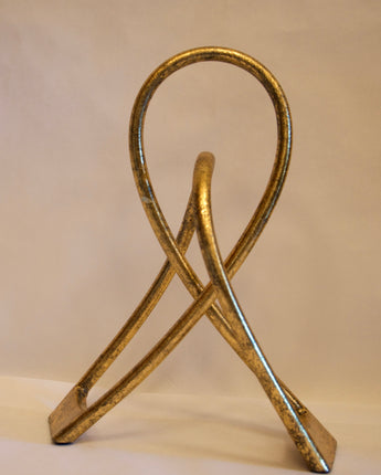 Decorative, continuous loop sculpture with gold leafing.